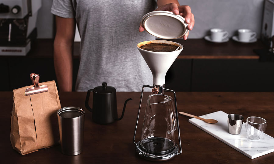 Person brewing coffee using a Pour Over Coffee Maker