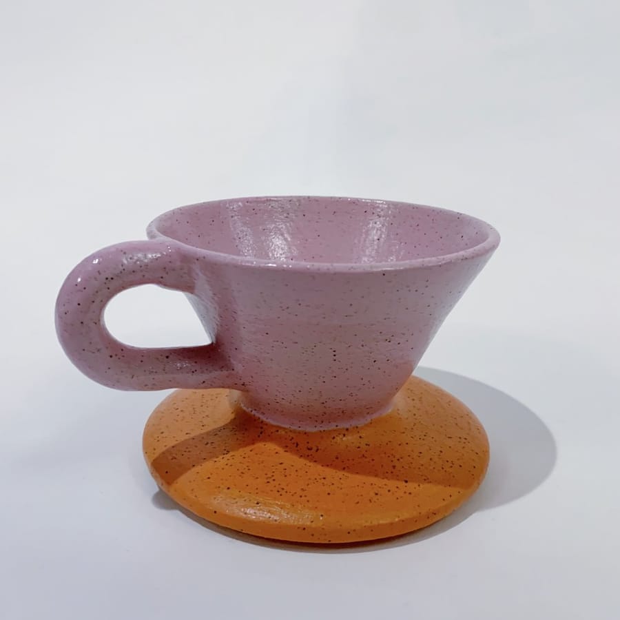 Hot coffee being poured over in a white ceramic funnel