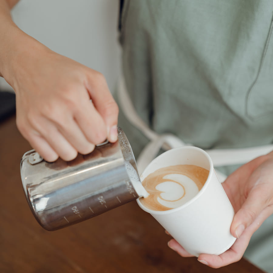 Person meticulously preparing pour over coffee